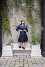 Load image into Gallery viewer, Beautiful brunette Russian model wearing silk satin kimono dress called Anatolé in night blue color. Front view image. Nynolia brand.