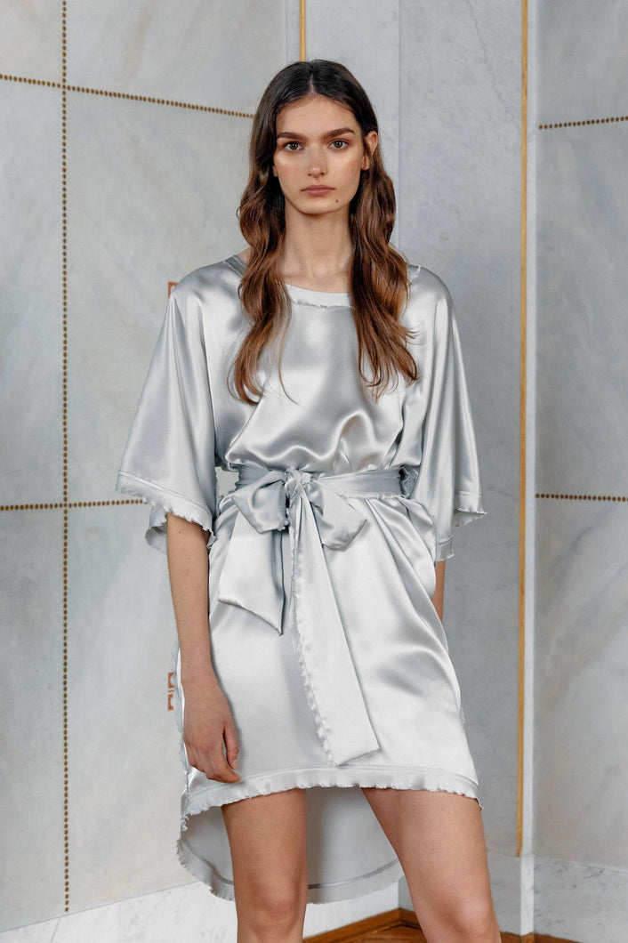 Brunette model wearing pure satin silk dress Celine in silver color front view