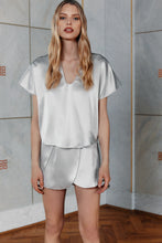 Load image into Gallery viewer, Beautiful blonde wearing sustainable satin silk top Pieris in silver color front view
