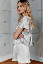 Load image into Gallery viewer, Beautiful blonde wearing satin silk skirt Pieris in silver color side view
