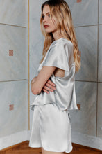 Load image into Gallery viewer, Beautiful blonde wearing sustainable satin silk top Pieris in silver color side view