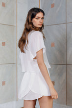 Load image into Gallery viewer, Beautiful brunette wearing sustainable silk skirt Pieris in white color rear view
