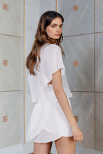 Load image into Gallery viewer, Beautiful brunette wearing sustainable silk skirt Pieris in white color rear view