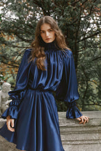 Load and play video in Gallery viewer, Brunette model wearing satin silk dress Kali in dark blue
