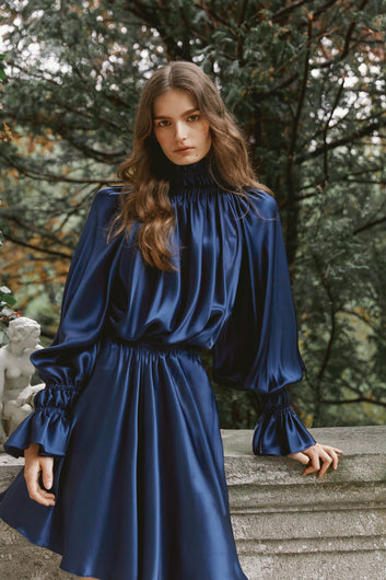Brunette model wearing satin silk dress Kali in dark blue