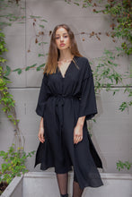 Load image into Gallery viewer, Beautiful brunette Russian model wearing silk satin kimono dress called Anatolé in matte black color. Front view image. Nynolia brand.
