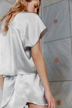 Load image into Gallery viewer, Beautiful blonde wearing sustainable satin silk top Pieris in silver color rear view

